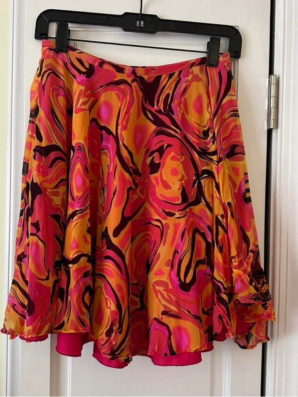 Betsey Johnson black label vibrant orange and pink swirl patterned silk skirt.